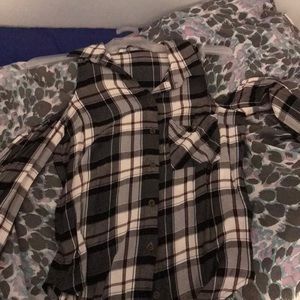 A long sleeve, off the shoulder plaid shirt